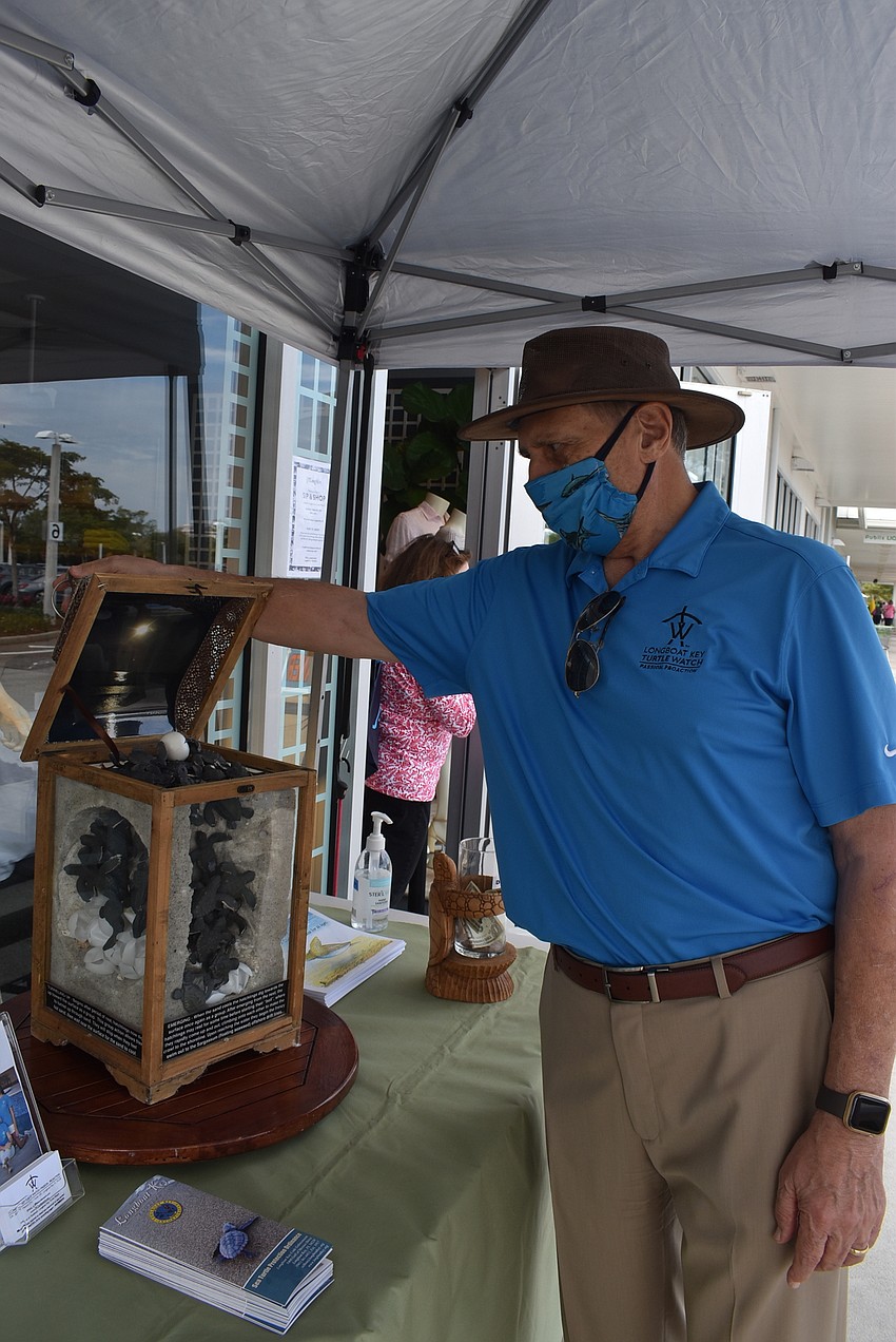 Sam DiGiammarino shows the life cycle of turtle eggs.
