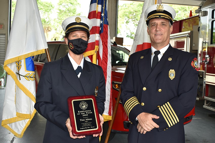 Fire Chief Paul Dezzi (right) named Fire Rescue liaison and public information officer Tina Adams (left) as the 2020 employee of the year.