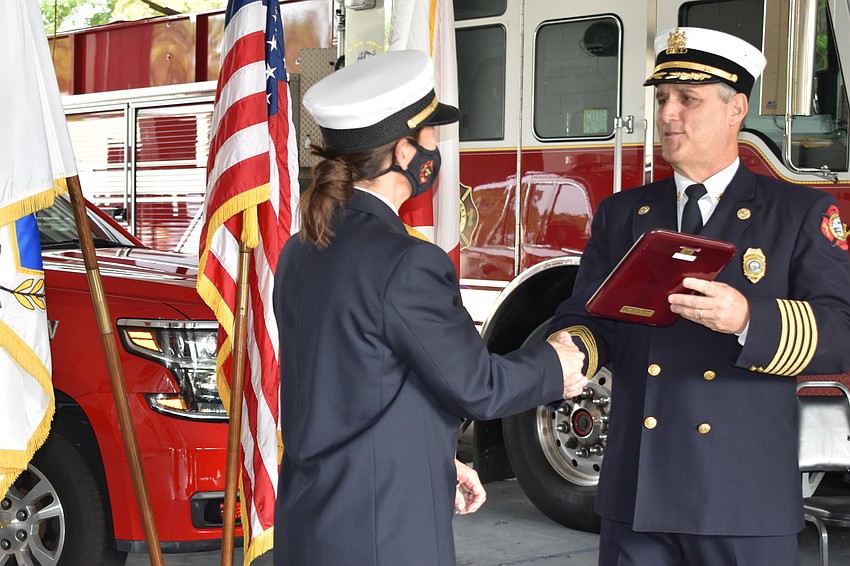 Fire Chief Paul Dezzi (right) named Fire Rescue liaison and public information officer Tina Adams (left) as the 2020 employee of the year.