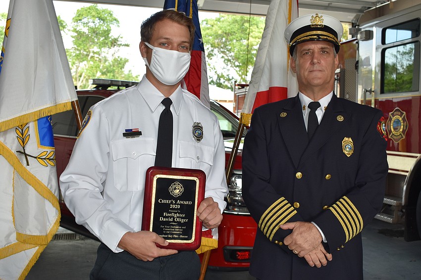 Firefighter and paramedic David Oliger (left) won the Fire Chief Award. Fire Chief Paul Dezzi (right) is pictured with Oliger.