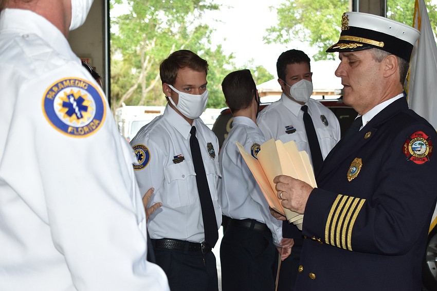 Fire Chief Paul Dezzi (right) distributes awards during Tuesday morning's ceremony.