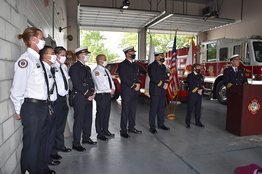 Fire Chief Paul Dezzi (right) offers congratulations during Tuesday morning's ceremony.