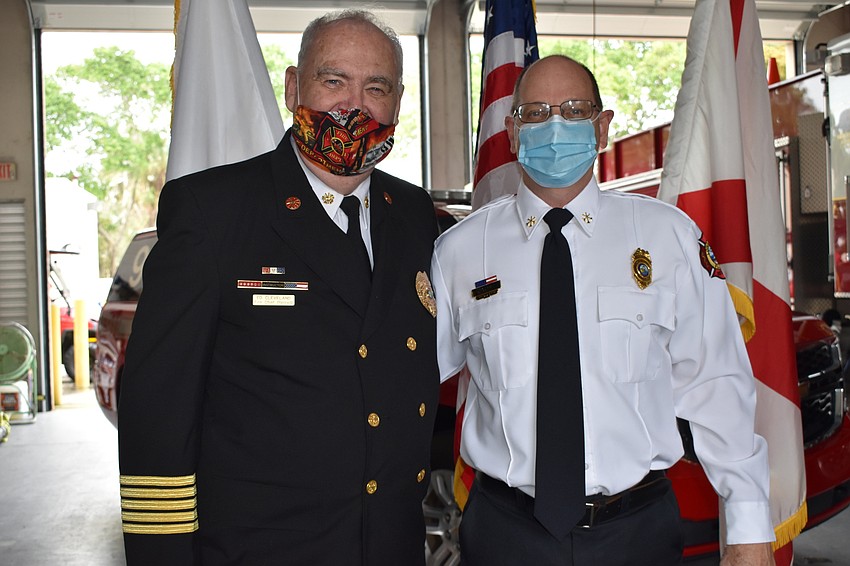 Ed Cleveland (left) and newly-appointed Assistant Chief John Curran (right) pose for a photo during Tuesday's ceremony.