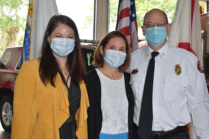 Newly-appointed Assistant Chief John Curran poses for a photo with his family during Tuesday's ceremony.