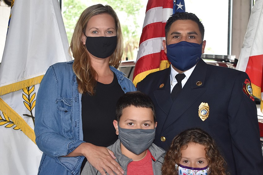 Newly-promoted Lt. Jose Rivera poses for a photo with his family at Tuesday morning's ceremony.