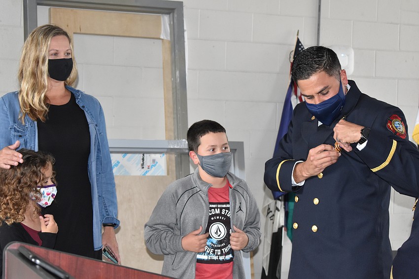 Newly-promoted Lt. Jose Rivera stands with his family at Tuesday morning's ceremony.