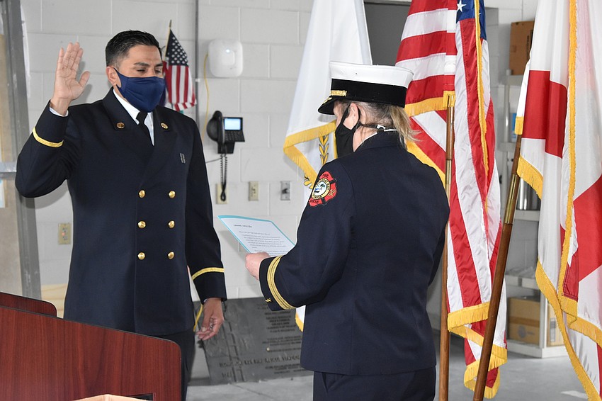 Newly-promoted Lt. Jose Rivera gets sworn in by Deputy Chief Sandi Drake.