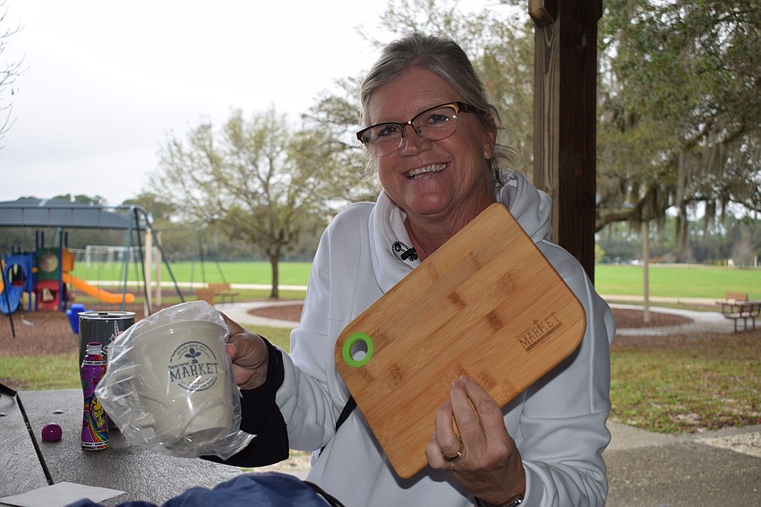 Greyhawk Landing's Cara Laney shows off the prizes she won in the first round of bingo. Prizes included gift bags from Lakewood Ranch Main Street and a gift card to Grove.