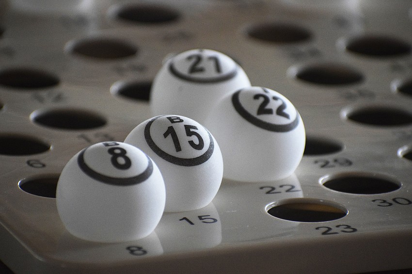 Bingo balls are laid out so they can be checked against a winning card to ensure victory.