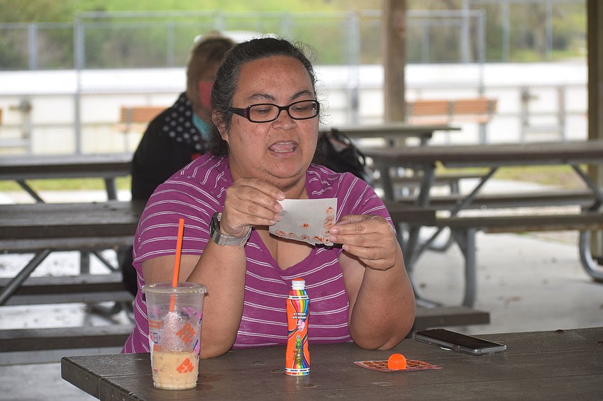 Parrish's Stephanie Moore reads off the numbers of her winning card. She won by getting all the numbers in an L-shape on her card.