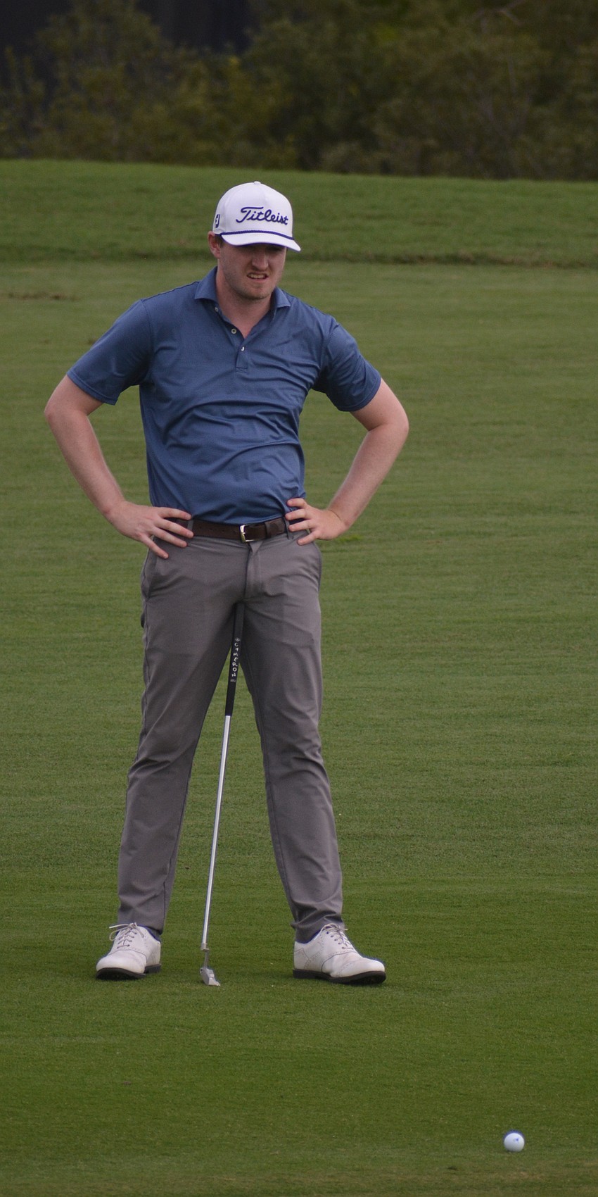 Ryan Siegler stands in a unique position while inspecting his putt on the No. 17 hole at Lakewood National. He would par the hole.
