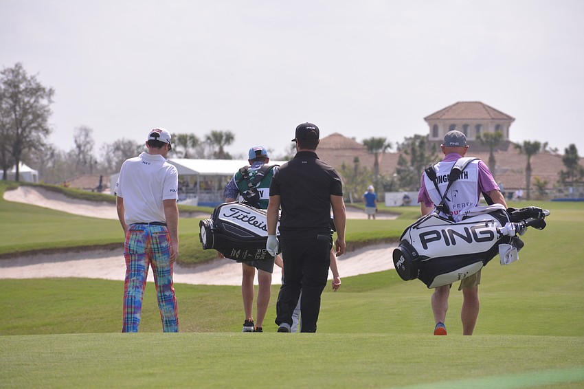 Drew Weaver (left) and David Lingmerth (center) walk alongside their caddies to find their balls on the No. 18 hole.