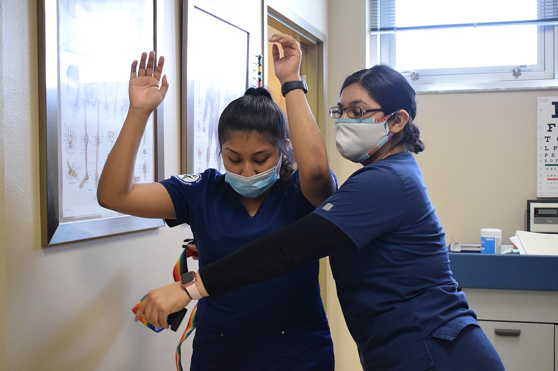 Medical Assisting students Esbeydi Penaloza and Jackie Pizano go through how to teach someone how to use a walker.
