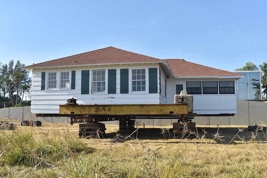 For now, the larger L-shaped cottage will temporarily sit on cribs near 6920 Gulf of Mexico Drive. Photo: Nat Kaemmerer