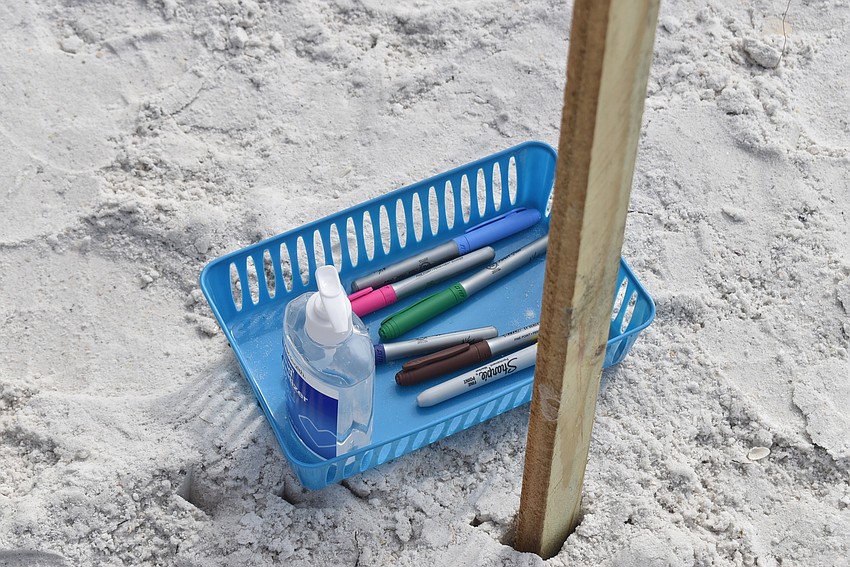 Hand sanitizer and markers were available if attendees wanted to write names of a loved one who died from complications of COVID-19.