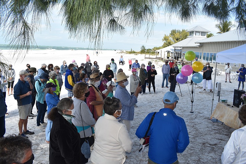 A crowd of masked attendees gathered to hear Cathy Tobias speak.