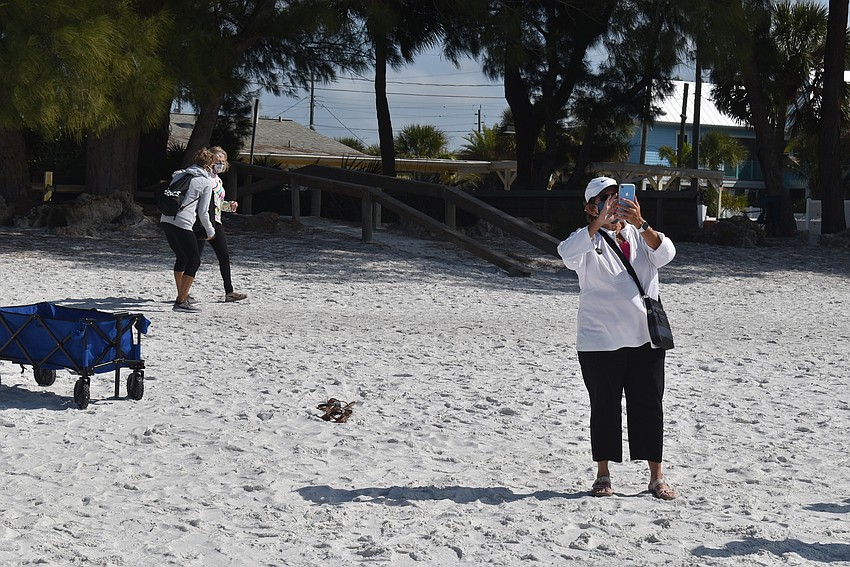 Judy Tobias snapped photos as attendees began to lift ribbons.