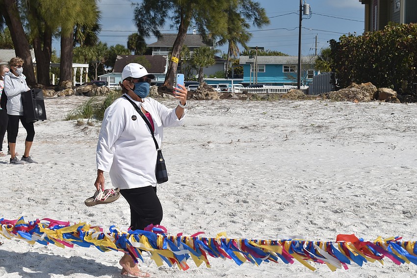 Judy Tobias snapped photos as attendees began to lift ribbons.