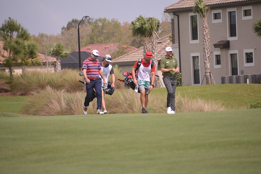 Taylor Pendrith and Paul Barjon walk to find their tee shots on the No. 18 hole. Pendrith finished three under par for the round. Barjon finished one over par on the day.