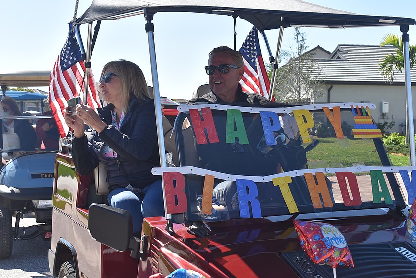 Del Webb residents Peggy and Jerry Hufford wish Rose Bauer a happy birthday. About 150 people participated in the parade.