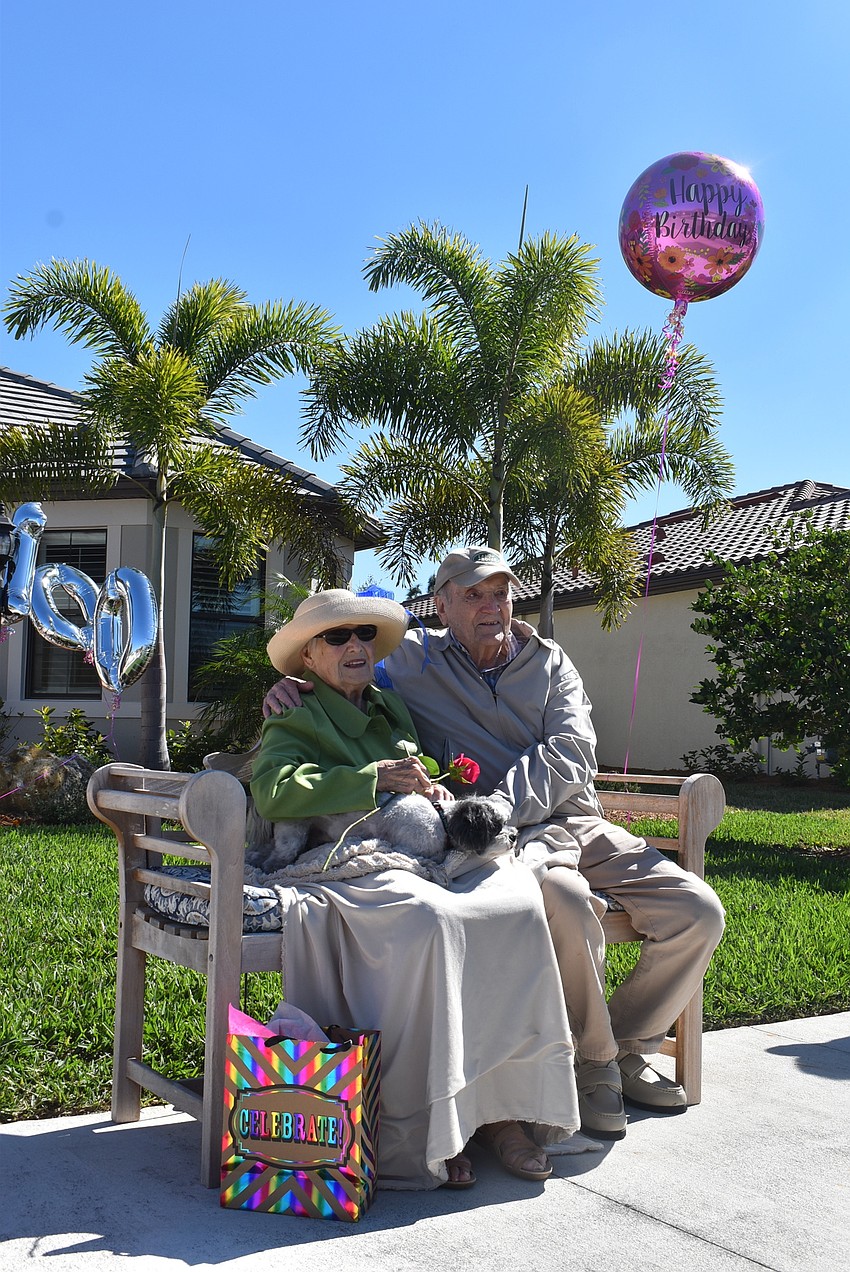 Rose and Reinhard Bauer sit and watch the parade that was organized to surprise Rose Bauer. They will celebrate their 75th anniversary July 27.