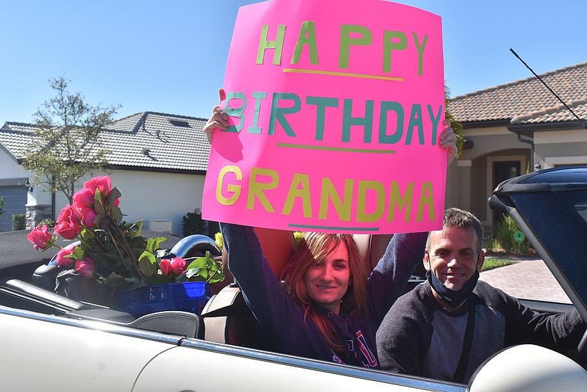 Jen Bauer and Scott Bauer surprised Rose Bauer by appearing in the parade. Scott Bauer is Rose's grandson, and Jen Bauer is his wife. They had not seen their grandmother in about a year.