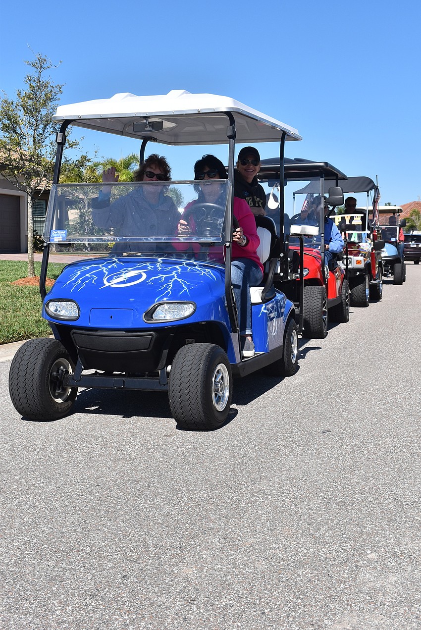 Del Webb residents Karin Litcher, Robin Rothman and Robin Cohen are part of a long procession of vehicles passing by Rose Bauer. Several renditions of Happy Birthday were sung as the carts passed.