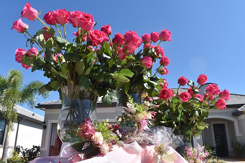 Ninety-nine roses sit in an arrangement after the end of the parade. Rose Bauer kept one rose in her hand.