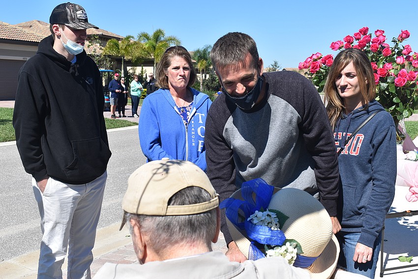 Great-grandson Matthew Bauer, granddaughter-in-law Beth Bauer, grandson Scott Bauer and granddaughter-in-law Jen Bauer talk with Reinhard Bauer and Rose Bauer after the parade. Rose Bauer had not seen them in about a year.