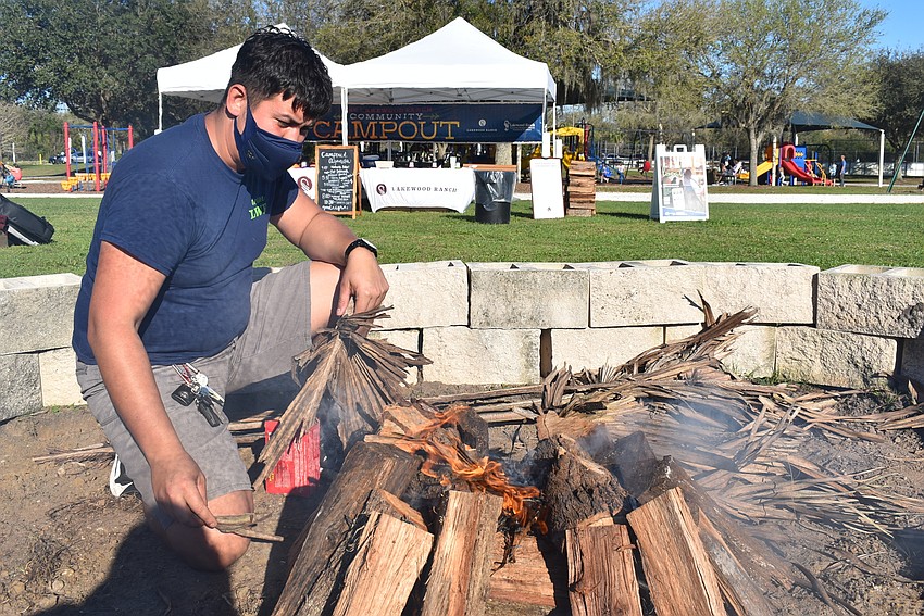 Lakewood Ranch employee Antonio Hernandez tends to the bonfire. He said Lakewood Ranch wasn't providing a communal s'mores table this year because of the COVID-19 pandemic, but plenty of families brought their own supplies.