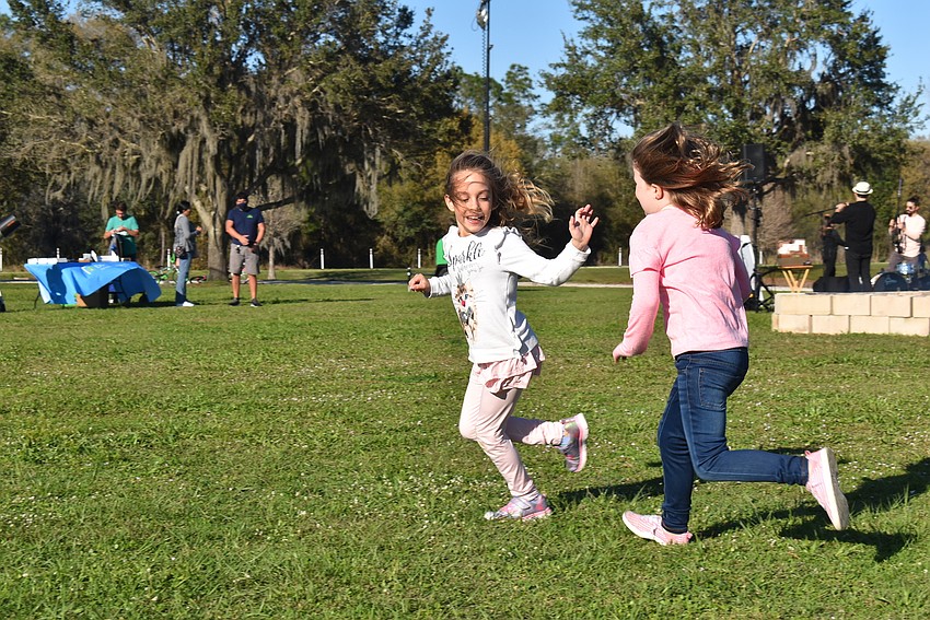 Greenbrook residents Madelynn Bente, 7, and Mary Anne Poulton, 6, enjoy a game of tag. They camped together because their moms have been best friends since the eighth grade.