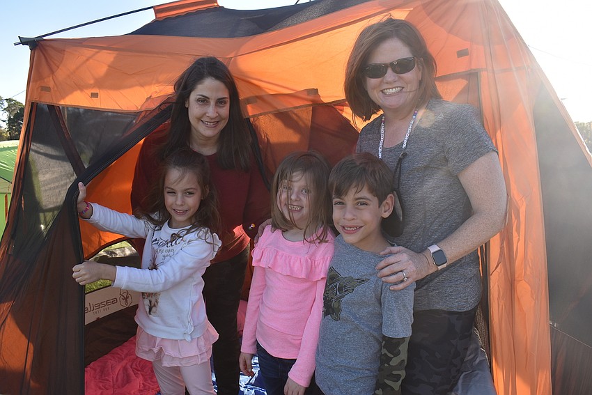 Greenbrook residents Michelle Bente and Tara Poulton, best friends since eighth grade, stand with their kids, Madelynn Bente, 7, Mary Anne Poulton, 6, and Mason Bente, 7, at the entrance to their tent.