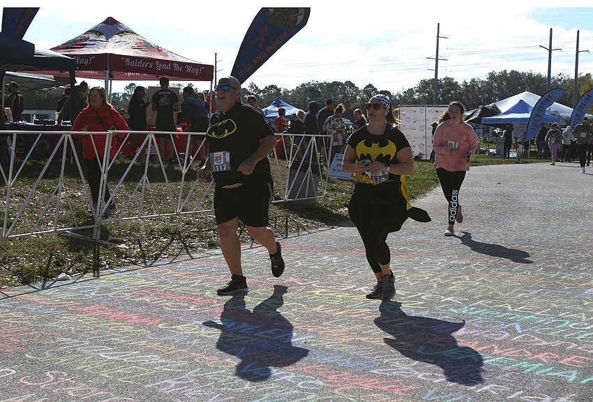 Paul and Brittany Page ran with Batman shirts.