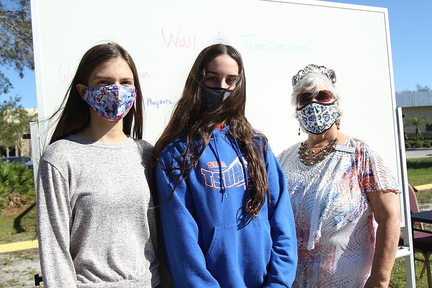 Olivia Graber, Ella Collier and Martha Magenheim wrote down kind words at the Wall of Togetherness.