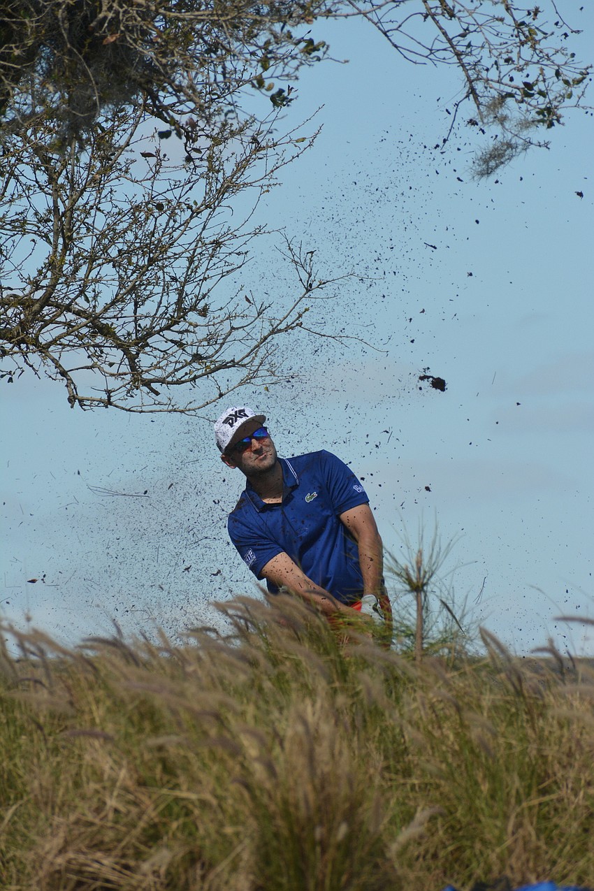 Paul Barjon hits his second shot on the No. 18 hole through the brush. Barjon would par the hole to finish three over par on the day, three under par for the tournament.