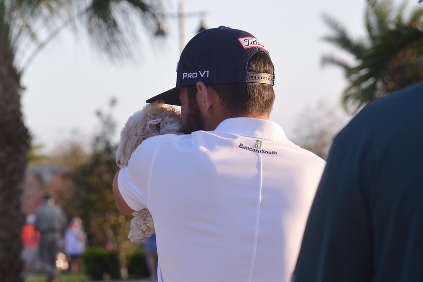 Hayden Buckley gives a kiss to his dog, Macy, following his win at the 2021 LECOM Suncoast Classic.
