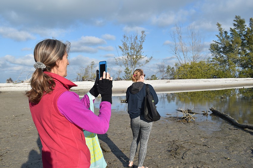 Cyndi Seamon and Carlyn Vigil stopped to watch herons getting breakfast.