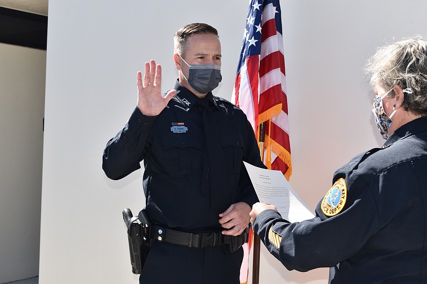 Doug Ferris (left) was sworn in as a Longboat Key police officer by Chief Kelli Smith (right).