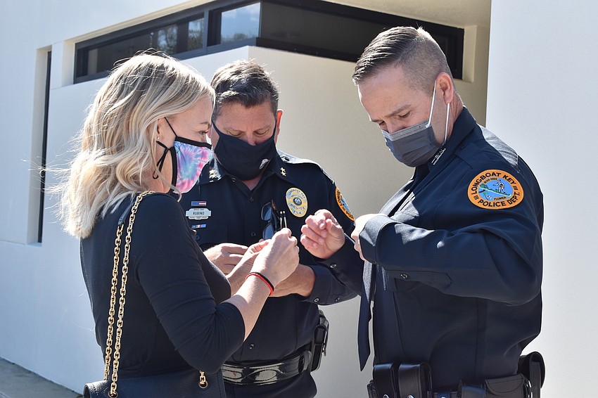 Doug Ferris’ wife Kari pinned him during Tuesday morning’s swearing-in ceremony. Deputy Chief Frank Rubino stands in the middle.