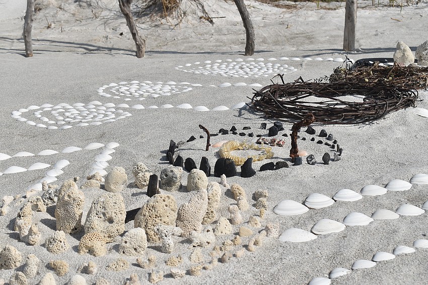 Bits of coral end a line of circles through the middle of the piece.