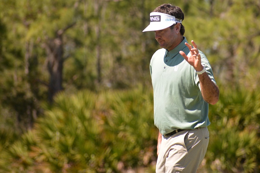 Bubba Watson waves to the crowd at the No. 11 hole after making a birdie putt. Watson would finish five over par for the round.