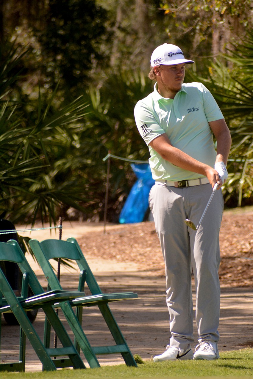 Sami Valimaki chips from the edge of the course on the No. 11 hole at The Concession Golf Club. Valimaki would par the hole and finish the round at even par.