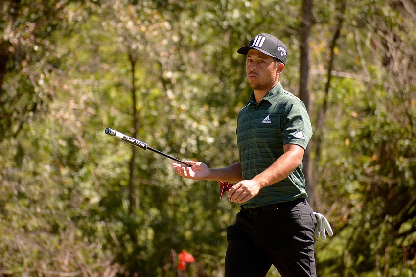 World No. 4-ranked Xander Schauffele twirls his golf cub after finishing the No. 10 hole at The Concession Golf Club. Schauffele parred the hole and would finish the round one under par.