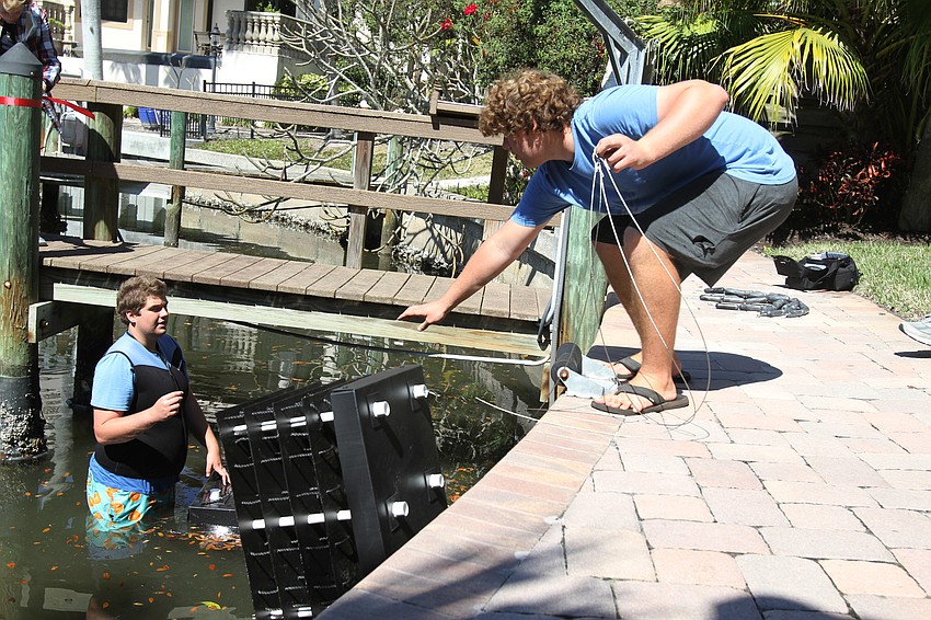 Alex Wolff dropped a reef down for David Wolff Jr. to place in the canal.