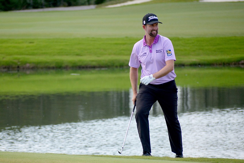 Webb Simpson laughs at the crowd on the No. 18 green after sinking a chip shot for a birdie.