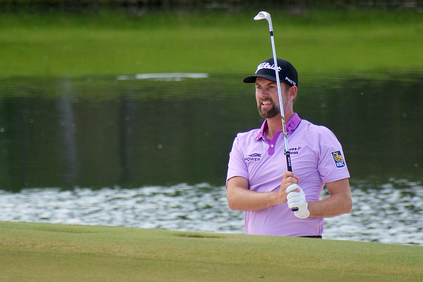 Webb Simpson studies his chip shot on the No. 18 hole at The Concession Golf Club. Simpson, who entered the day tied for the lead, would birdie the hole. He shot three under par for the round and is nine under par overall (T5).