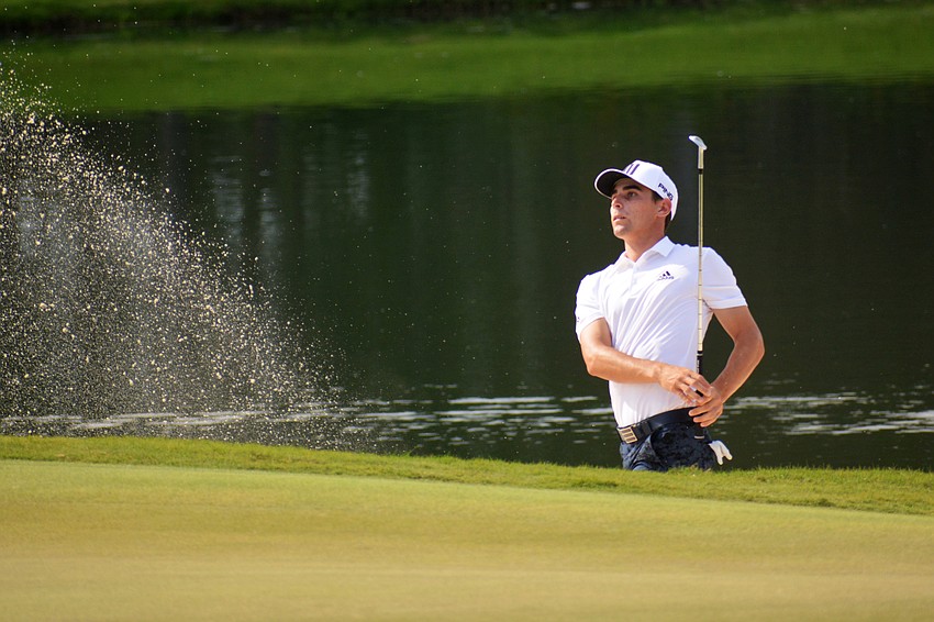 Joaquin Niemann kicks up sand with his chip shot on the No. 18 hole at The Concession Golf Club. Niemann would bogey the hole. He shot even par for the round and is three under par overall.