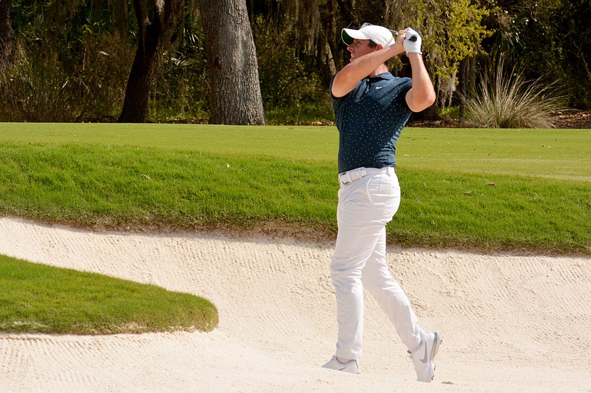 Rory McIlroy hits out of a bunker on the No. 9 hole at The Concession Golf Club. McIlroy would birdie the hole.