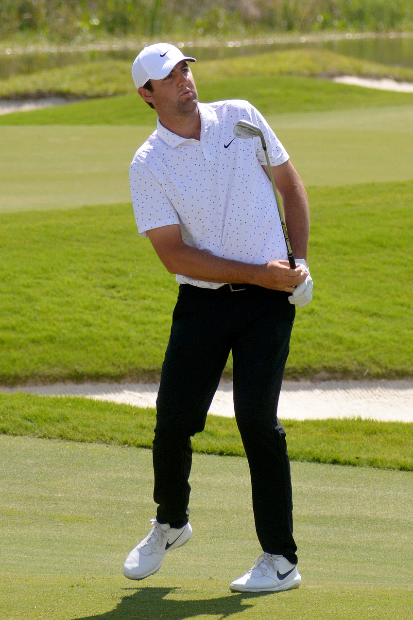 Scottie Scheffler watches his chip shot on the No. 12 hole at The Concession Golf Club. Scheffler would par the hole. He shot two under par for the round and is five under par overall.