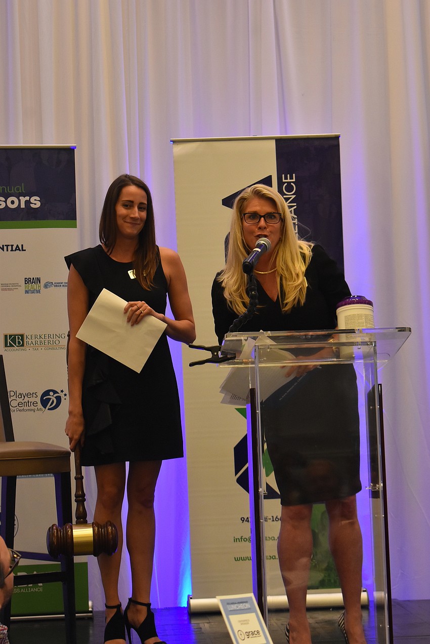 Lakewood Ranch Business Alliance 2021 Board Chair Amanda Parrish receives a gavel from previous Board Chair Lisa Kirkland. 